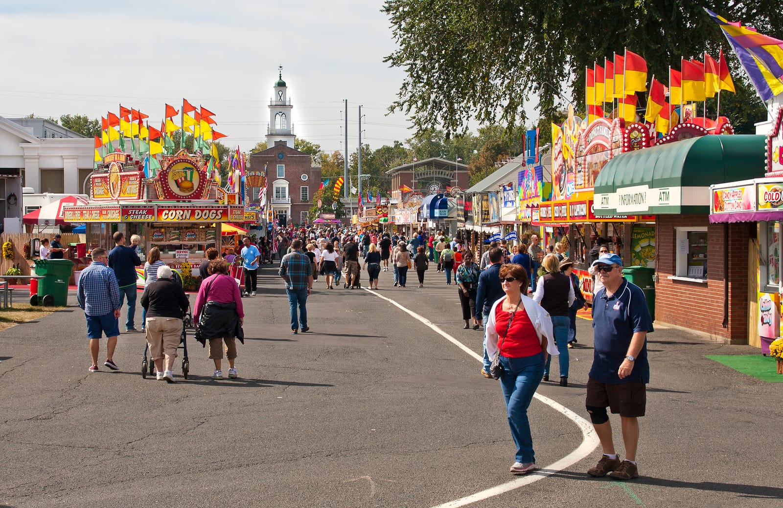 Visitors walking among food stands and New England state flags at The Big E in 2014